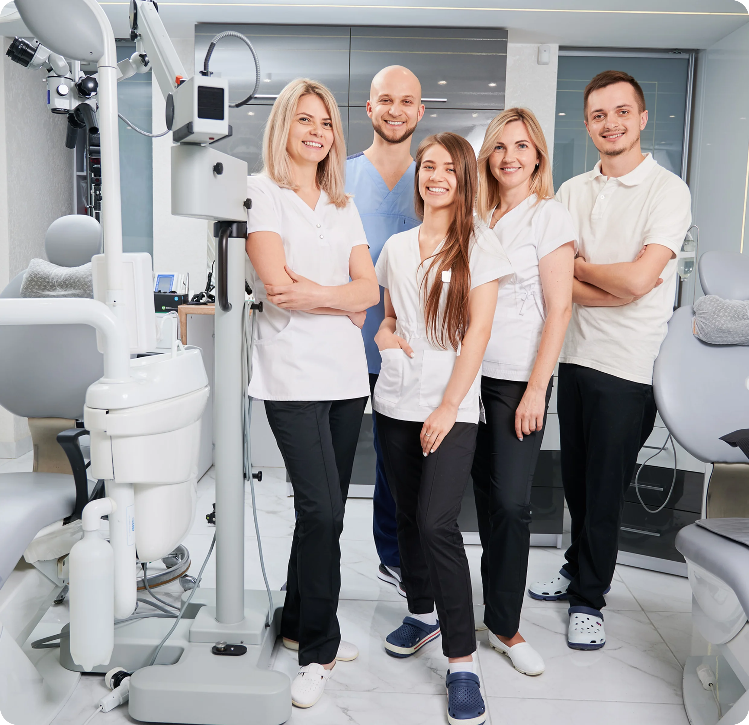 Dental team smiling in modern clinic setting.