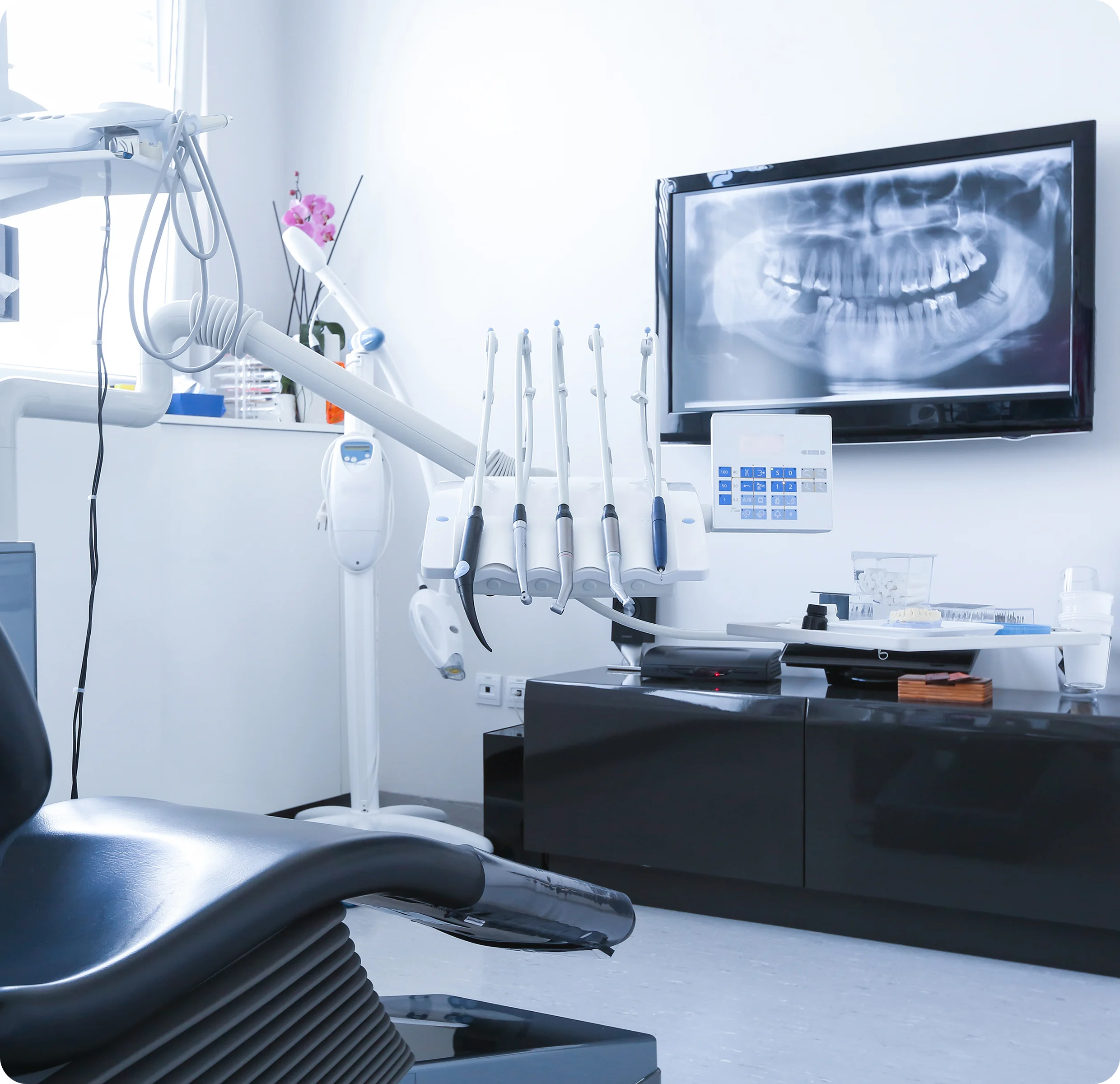 Dental office with chair and X-ray display.